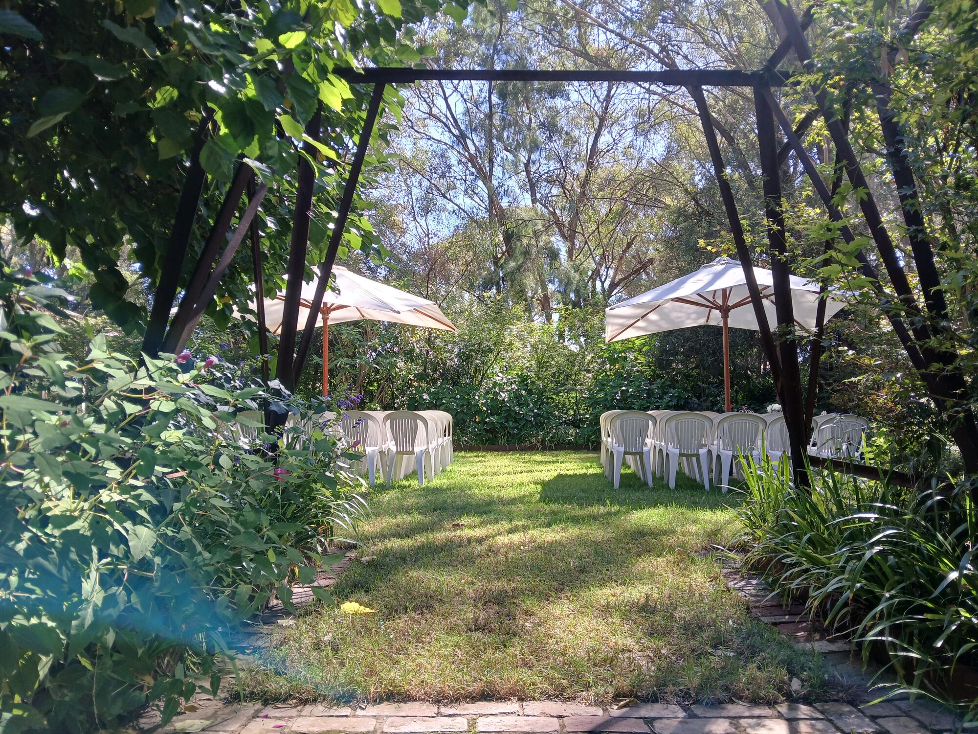 Garden ceremony arch with umbrellas at Paradise Gardens