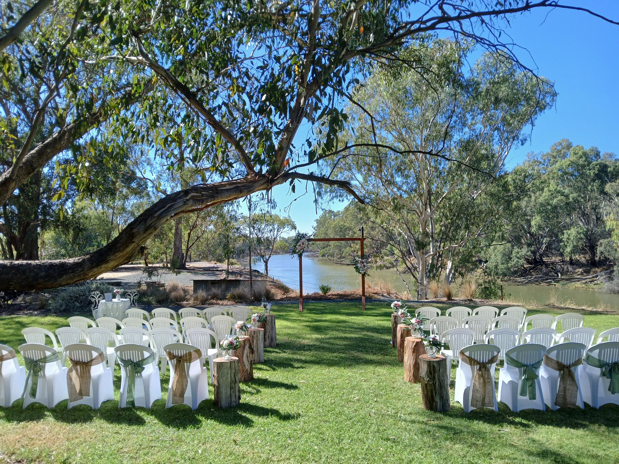Ceremony setup on the riverbank at Paradise Gardens