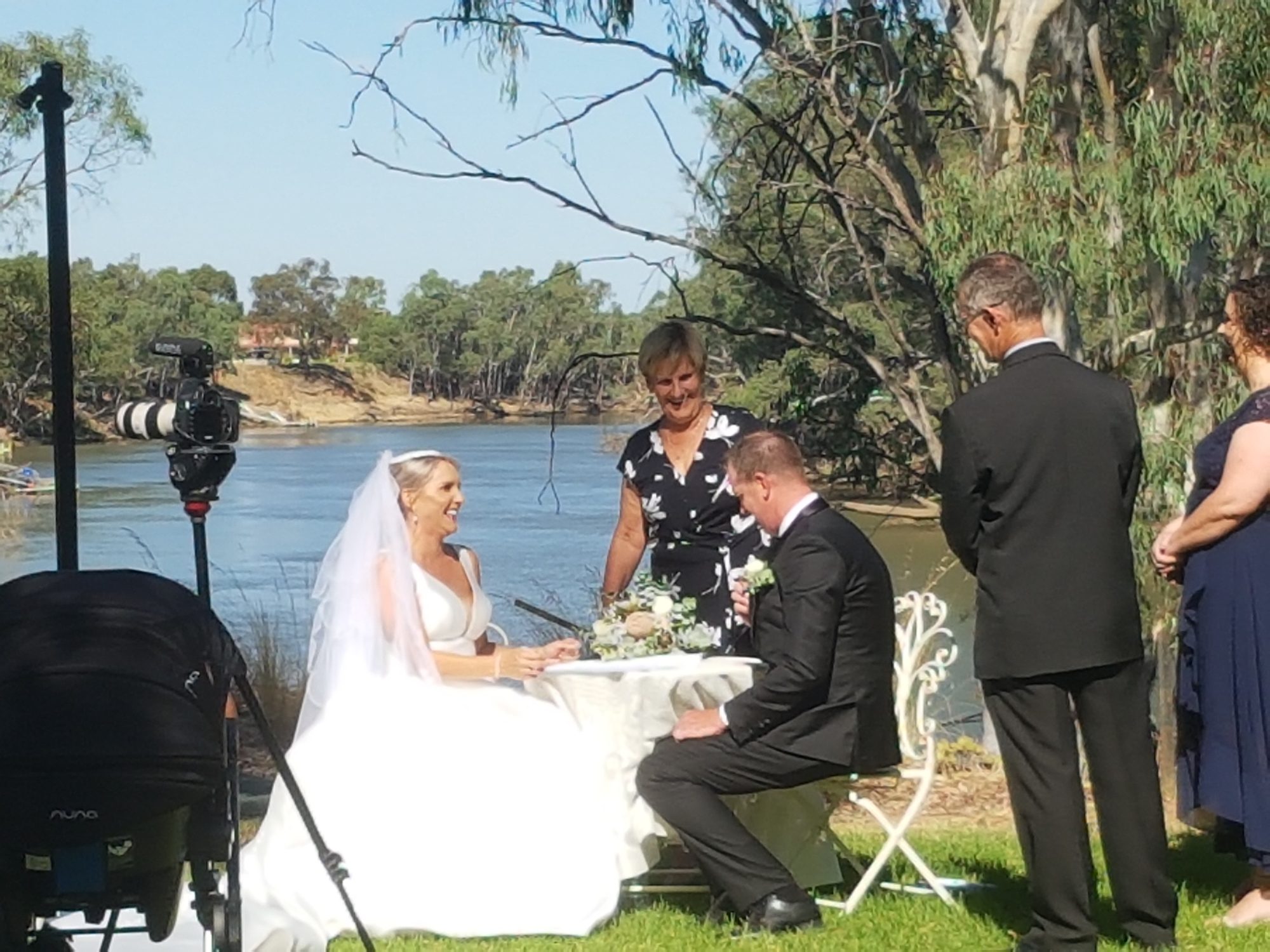 Couple signing the register beside the Murray River
