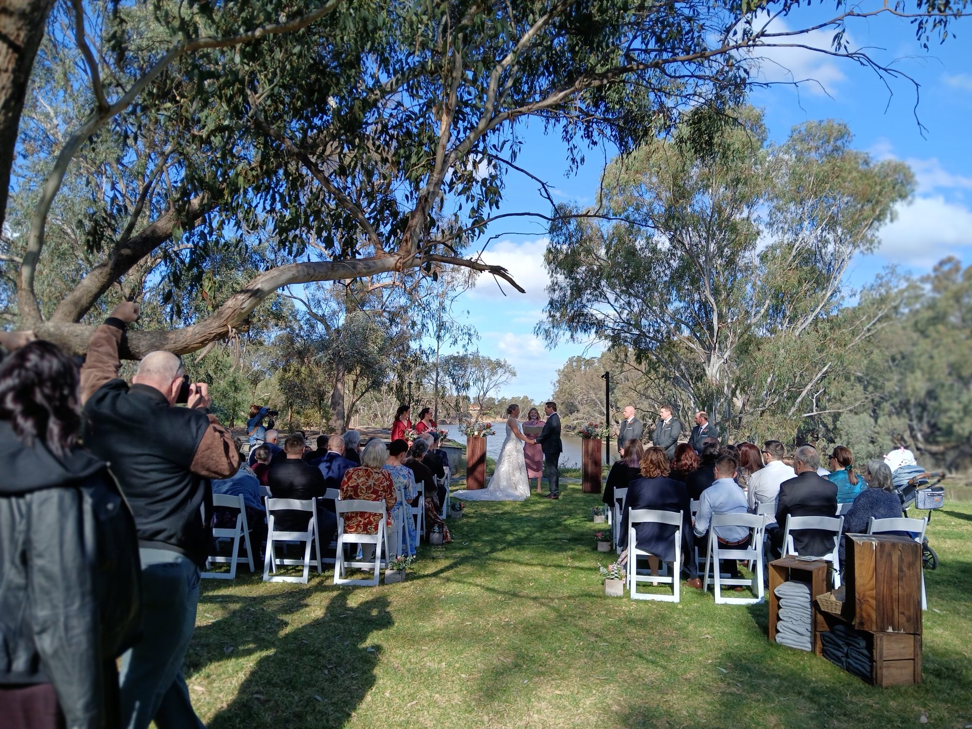 Riverbank ceremony seen from the back of the aisle, the river beyond Riverbank ceremony seen from the back of the aisle, the river beyond